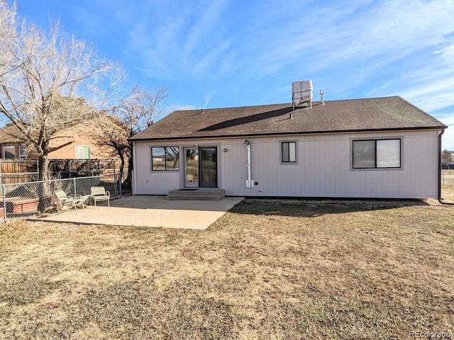 rear view of property featuring a yard and a patio