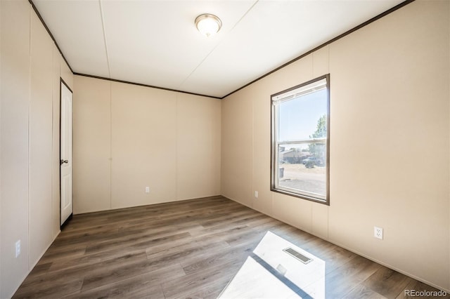 unfurnished room with hardwood / wood-style floors