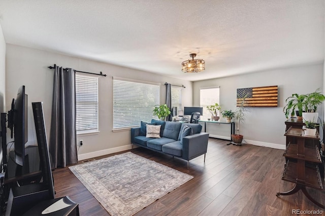 living room featuring dark hardwood / wood-style floors and a textured ceiling