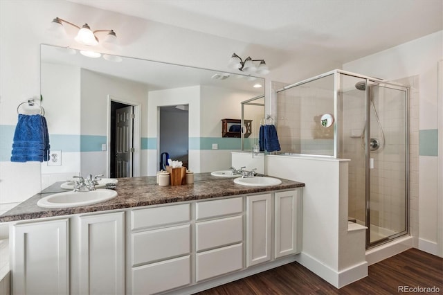 bathroom featuring vanity, hardwood / wood-style flooring, and walk in shower