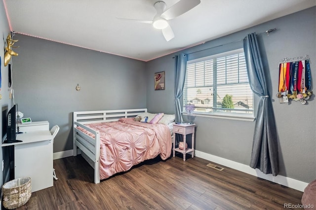 bedroom with dark hardwood / wood-style flooring and ceiling fan