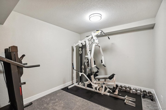 workout area with a textured ceiling and carpet