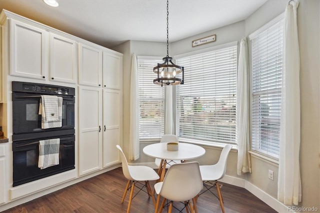 dining room featuring dark hardwood / wood-style flooring and a chandelier