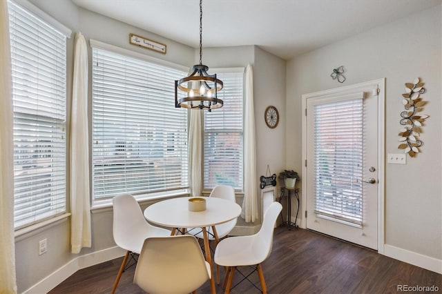 dining room with a notable chandelier, dark hardwood / wood-style floors, and plenty of natural light