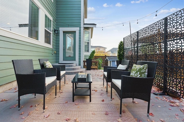 view of patio featuring a shed and outdoor lounge area