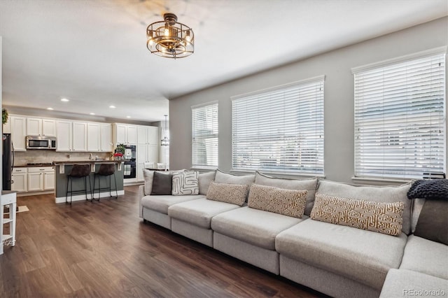 living room with dark hardwood / wood-style flooring