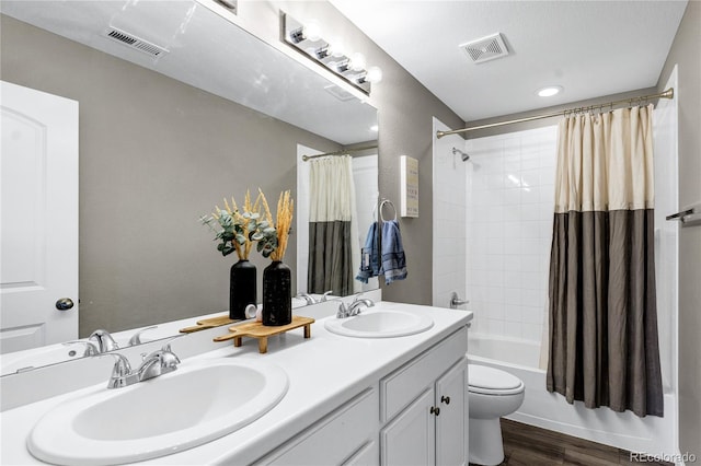 full bathroom featuring toilet, shower / tub combo, vanity, and hardwood / wood-style flooring