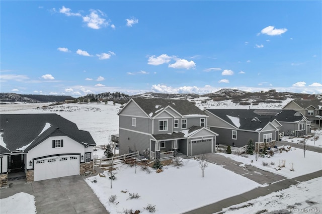 snowy aerial view with a mountain view