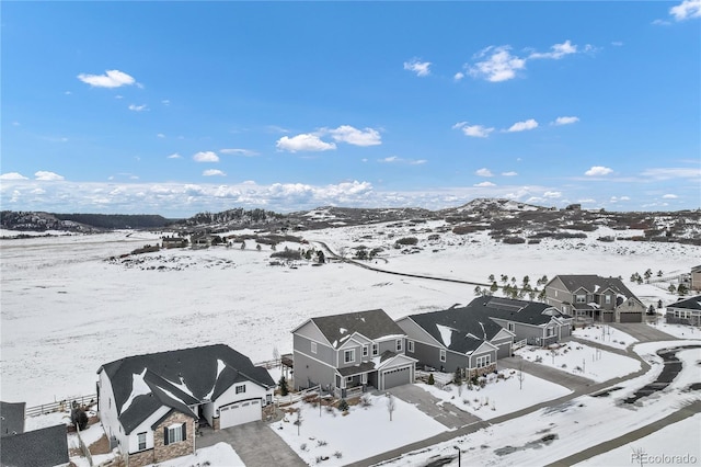 snowy aerial view featuring a mountain view