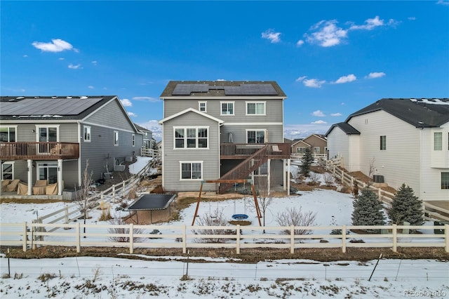 snow covered property with solar panels