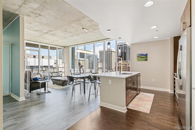 891 14th St Unit 1408, Denver, CO 80202 - kitchen with dark wood-type flooring, fridge, a center island with sink, floor to ceiling windows, and open floor plan
