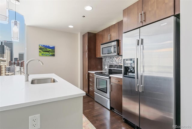 891 14th St Unit 1408, Denver, CO 80202 - kitchen with stainless steel appliances, dark wood-style floors, decorative backsplash, light countertops, and recessed lighting