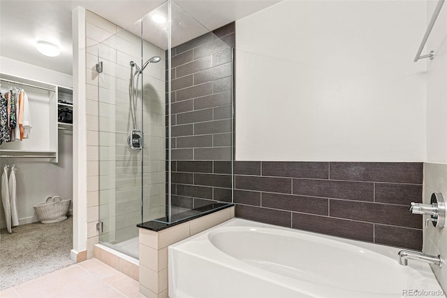 891 14th St Unit 1408, Denver, CO 80202 - full bathroom featuring a shower stall, a bath, a walk in closet, and tile patterned floors