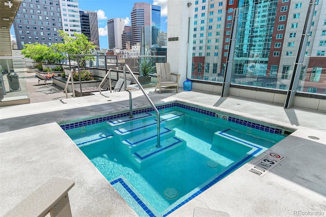 891 14th St Unit 1408, Denver, CO 80202 - view of pool featuring a hot tub, a view of skyline, and a patio area