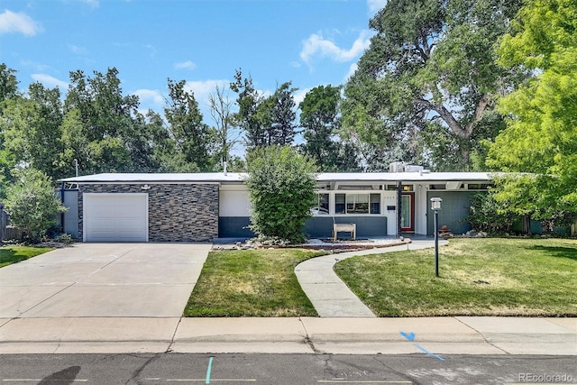 view of front of house with a garage and a front lawn