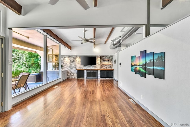 unfurnished living room featuring hardwood / wood-style flooring, vaulted ceiling with beams, and ceiling fan