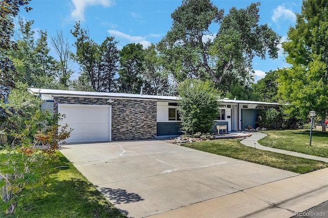 ranch-style house featuring a garage and a front yard