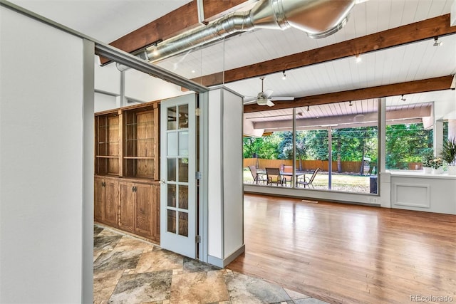 unfurnished sunroom with beamed ceiling and ceiling fan