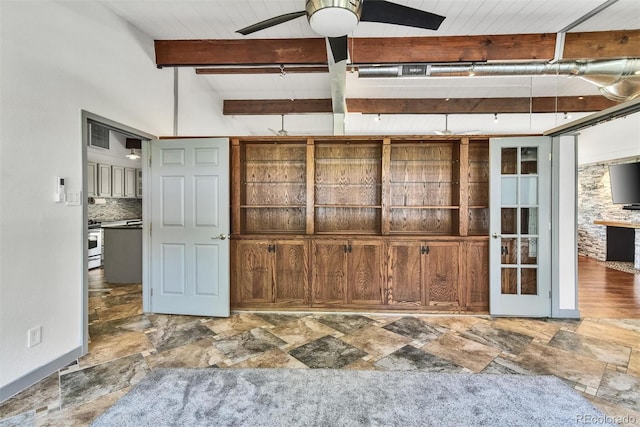 interior space with tile patterned flooring, beam ceiling, backsplash, ceiling fan, and stove