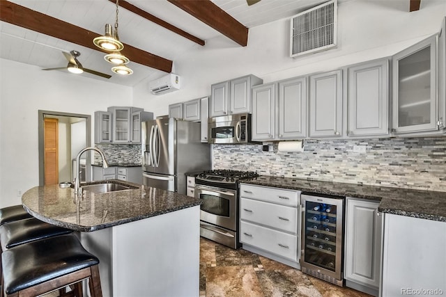 kitchen featuring ceiling fan, stainless steel appliances, dark tile patterned floors, beamed ceiling, and wine cooler