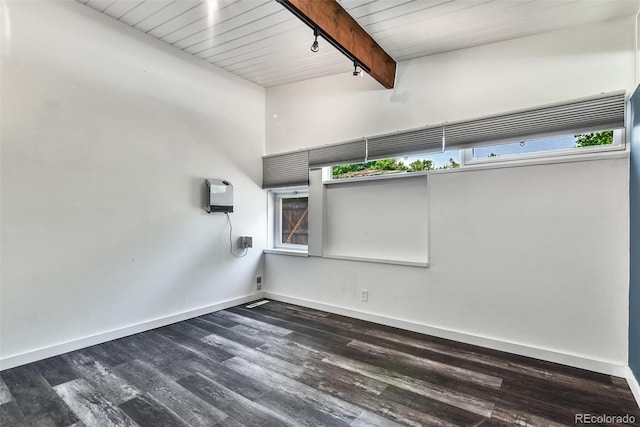 empty room featuring wood-type flooring, beam ceiling, a towering ceiling, and wood ceiling