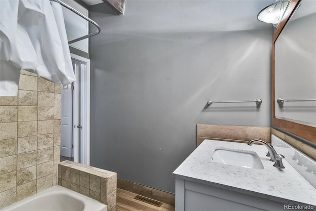 bathroom with vanity and  shower combination