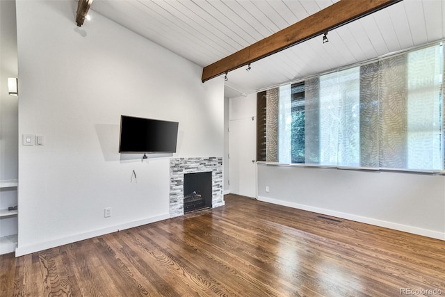 unfurnished living room with beam ceiling, a fireplace, and wood-type flooring