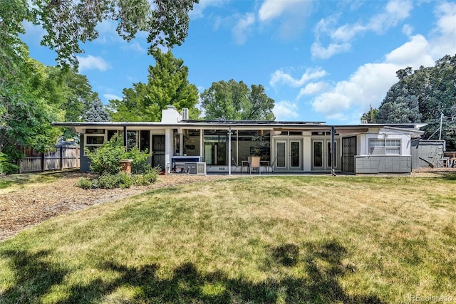 back of house featuring a lawn