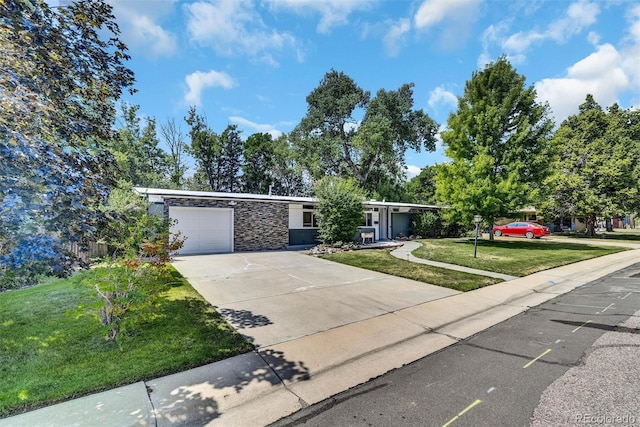 ranch-style home featuring a garage and a front lawn