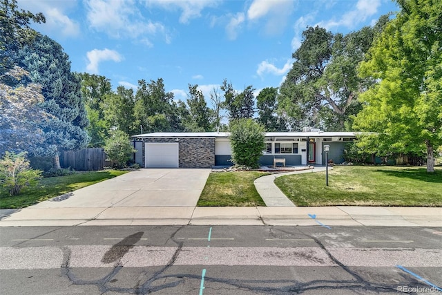 ranch-style home with a garage and a front yard