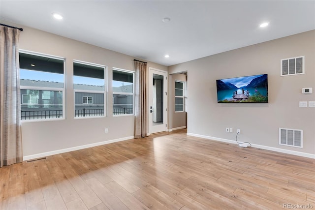 unfurnished living room featuring light hardwood / wood-style floors