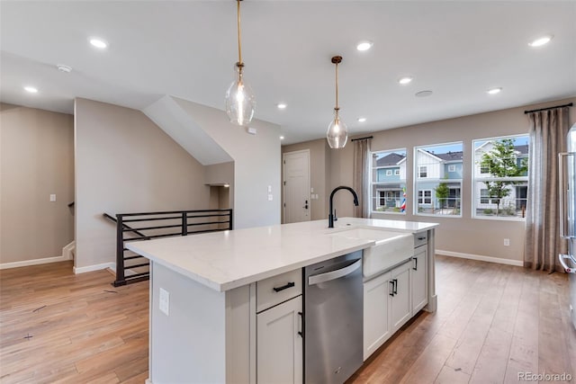 kitchen with a center island with sink, white cabinetry, sink, and stainless steel dishwasher