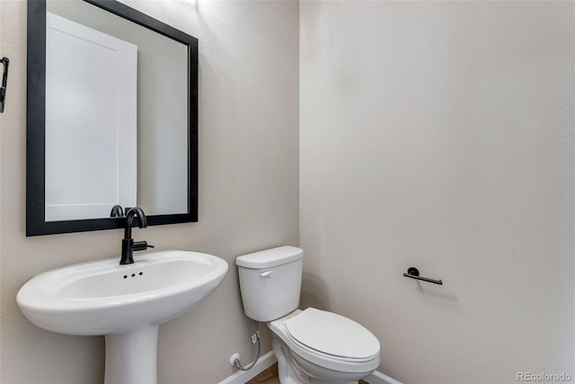 bathroom featuring sink and toilet