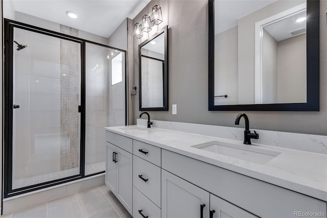 bathroom featuring walk in shower, tile patterned floors, and vanity