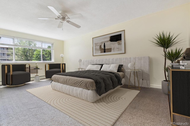 bedroom with a textured ceiling, carpet floors, and ceiling fan