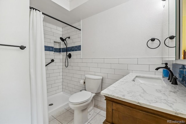 full bath featuring toilet, a stall shower, tile patterned floors, tile walls, and vanity