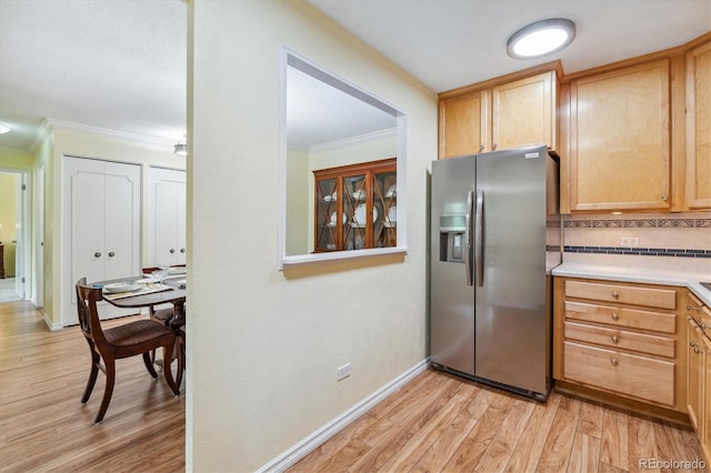 kitchen with backsplash, stainless steel fridge with ice dispenser, crown molding, and light hardwood / wood-style flooring