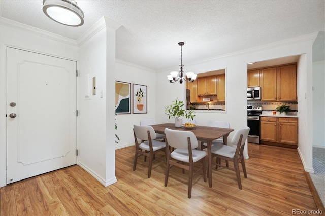 660 S Alton Way Unit 3B, Denver, CO 80247 - dining room featuring a chandelier, light wood-style floors, crown molding, baseboards, and a textured ceiling