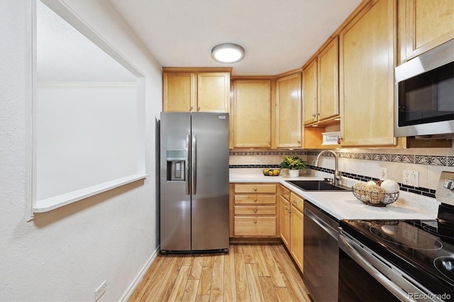 660 S Alton Way Unit 3B, Denver, CO 80247 - kitchen featuring appliances with stainless steel finishes, a sink, light wood-style flooring, backsplash, and light countertops