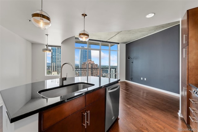 kitchen with dark hardwood / wood-style flooring, stainless steel dishwasher, hanging light fixtures, and sink