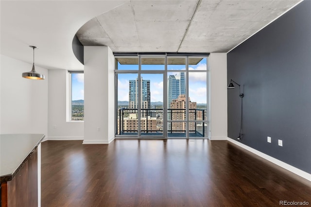 unfurnished living room featuring dark hardwood / wood-style floors and expansive windows