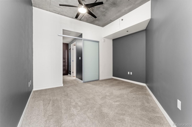 unfurnished bedroom with ceiling fan, light colored carpet, and a closet