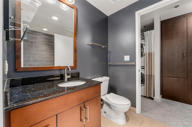 bathroom featuring vanity, stacked washer / drying machine, toilet, a shower with curtain, and tile patterned flooring