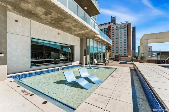 view of swimming pool with a patio