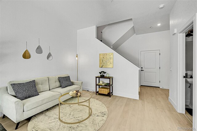 8530 W 52nd Ave Unit A1, Arvada, CO 80002 - living area featuring light wood-style floors, baseboards, stairway, and recessed lighting
