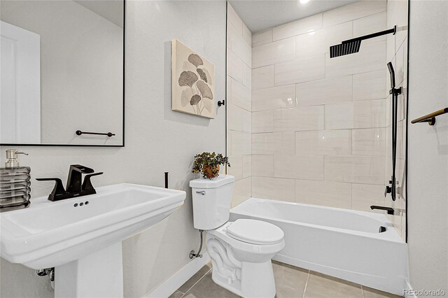 8530 W 52nd Ave Unit A1, Arvada, CO 80002 - bathroom featuring toilet, tile patterned floors, bathtub / shower combination, a sink, and baseboards