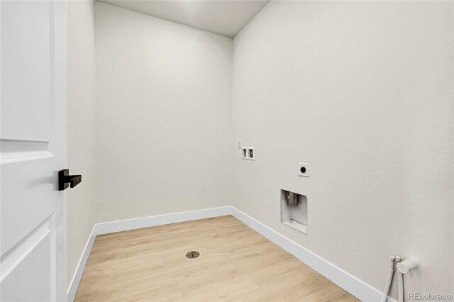 8530 W 52nd Ave Unit A1, Arvada, CO 80002 - washroom featuring washer hookup, hookup for an electric dryer, light wood finished floors, and baseboards