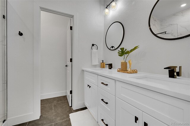 8530 W 52nd Ave Unit A1, Arvada, CO 80002 - full bathroom featuring double vanity, tile patterned floors, and a shower
