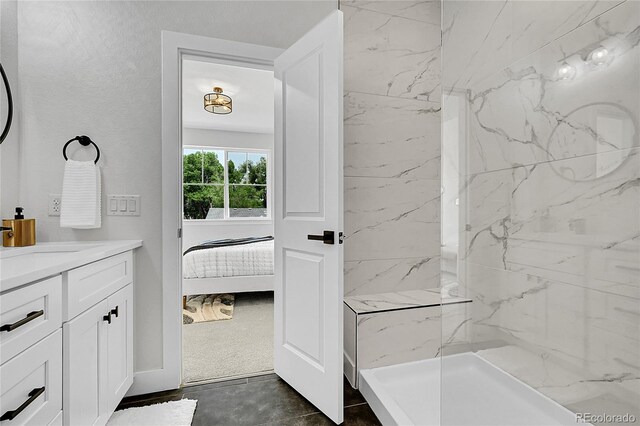 8530 W 52nd Ave Unit A1, Arvada, CO 80002 - ensuite bathroom featuring vanity and a marble finish shower