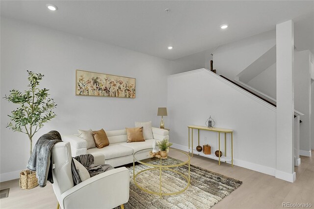 8530 W 52nd Ave Unit A1, Arvada, CO 80002 - living room featuring wood finished floors, recessed lighting, baseboards, and stairs
